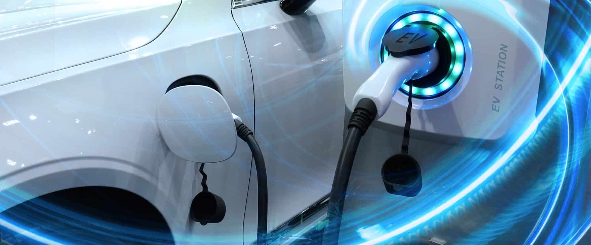 EV Car or Electric vehicle at charging station with the power cable supply plugged in on blurred nature with blue energy power effect. Eco-friendly sustainable energy concept.